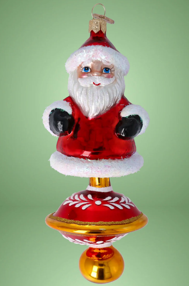 Ornament Merry Santa Claus on a spinning wheel